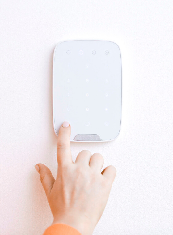 hand on home alarm system
