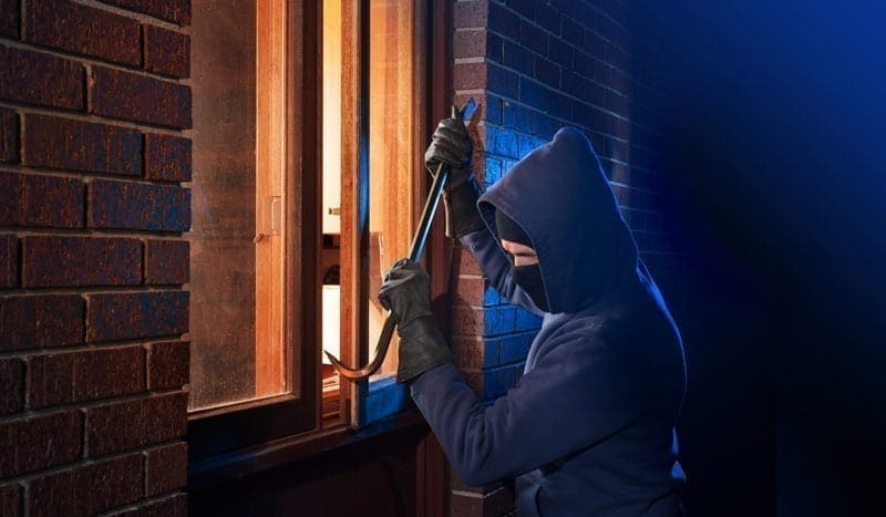 burglar-breaking-into-window